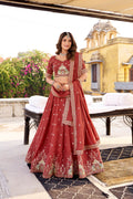 Rust crush silk lehenga choli adorned with detailed sequins and thread embroidery work, including matching dupatta