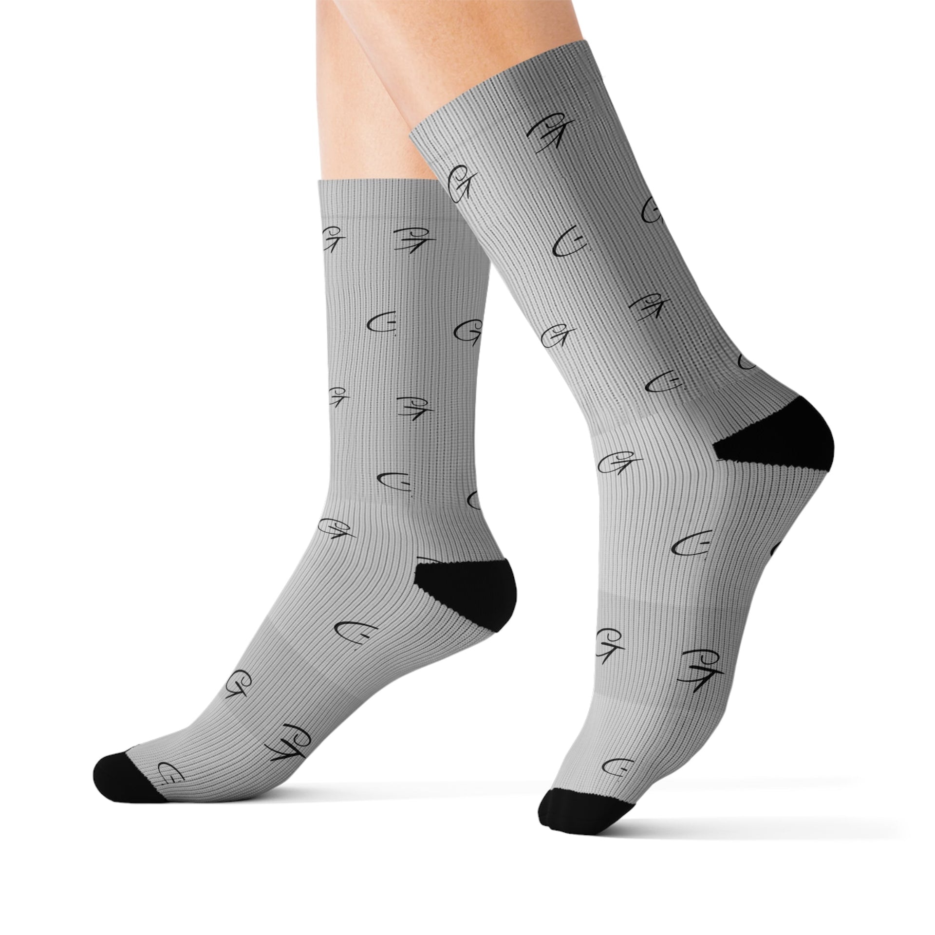 Unisex grey socks with geometric black pattern and Grayceful branding, featuring a ribbed tube and cushioned base.