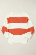 Flat lay of a white and orange striped V-neck sweater with drop shoulders and bubble sleeves, showcasing its knit texture.