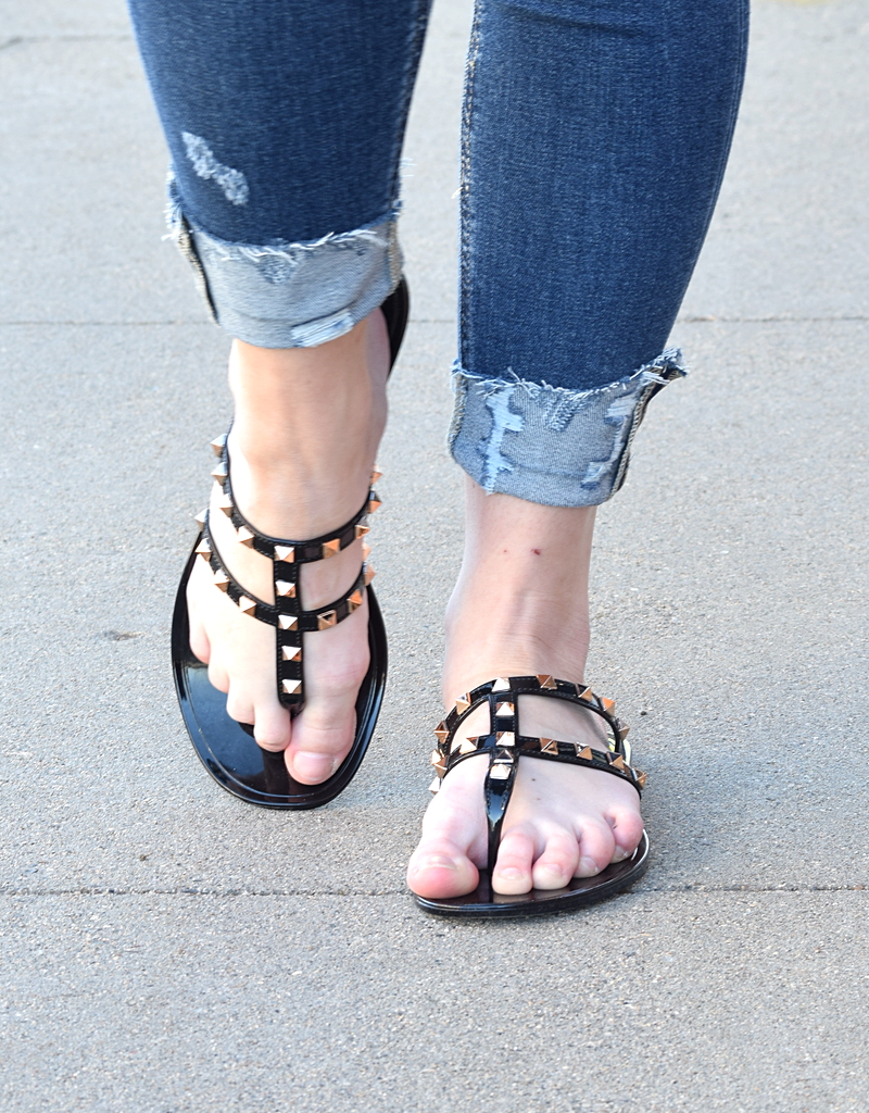 Close-up of a Boutique 23 flat sandal featuring studded detailing on a clean white background.