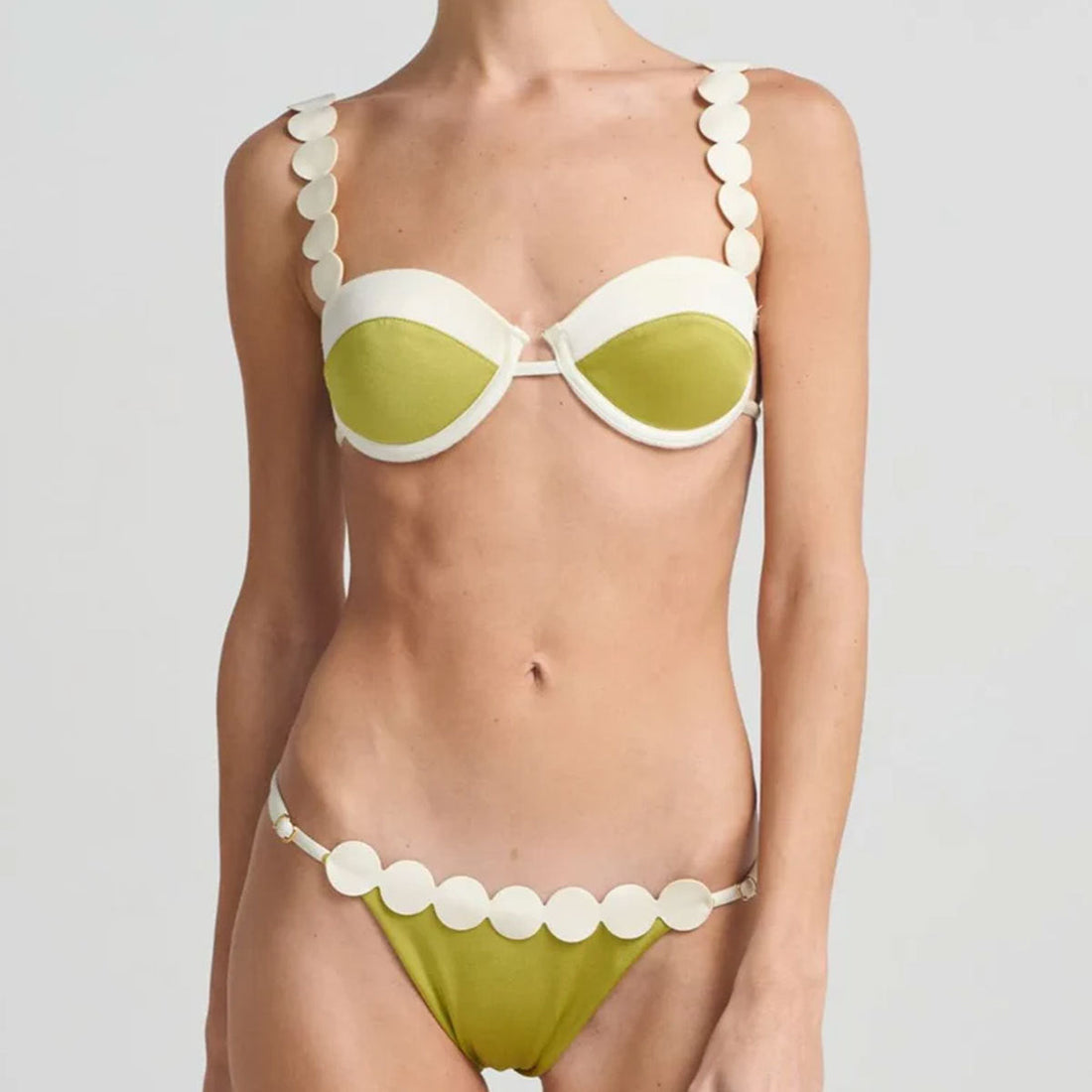 A backless color-block bikini set with ruched and lace details.