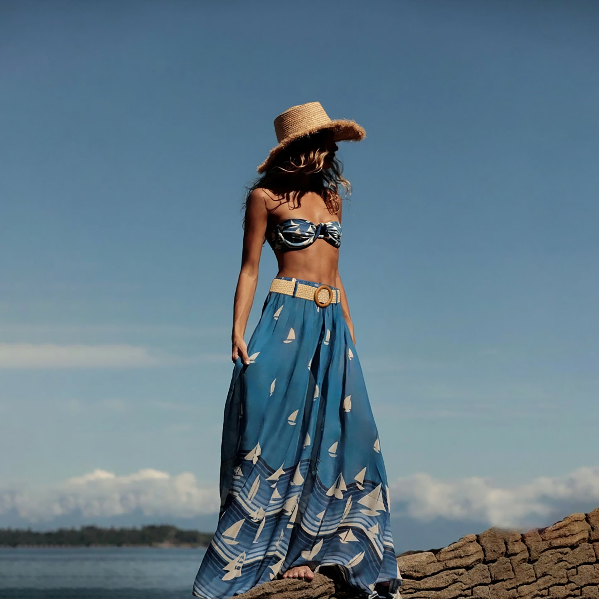 A stylish three-piece boho-inspired printed bikini set including a strapless tube top and low-waist banded skirt.