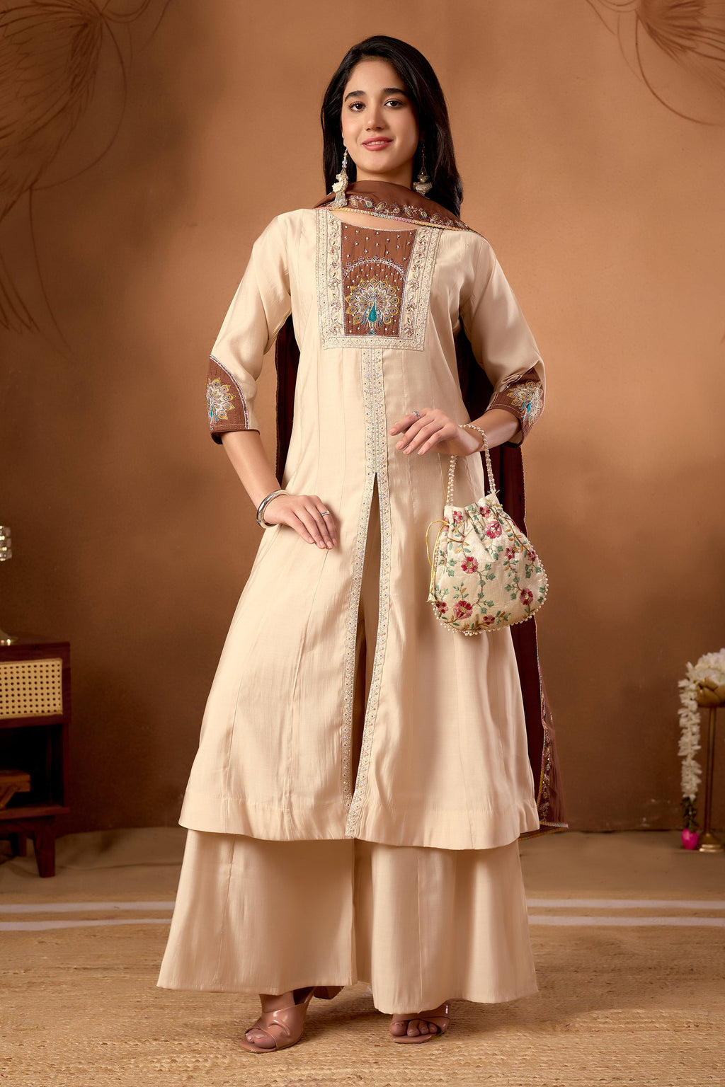Cream Roman Silk kurta with multi-color embroidery and handwork details worn as a set with matching palazzo