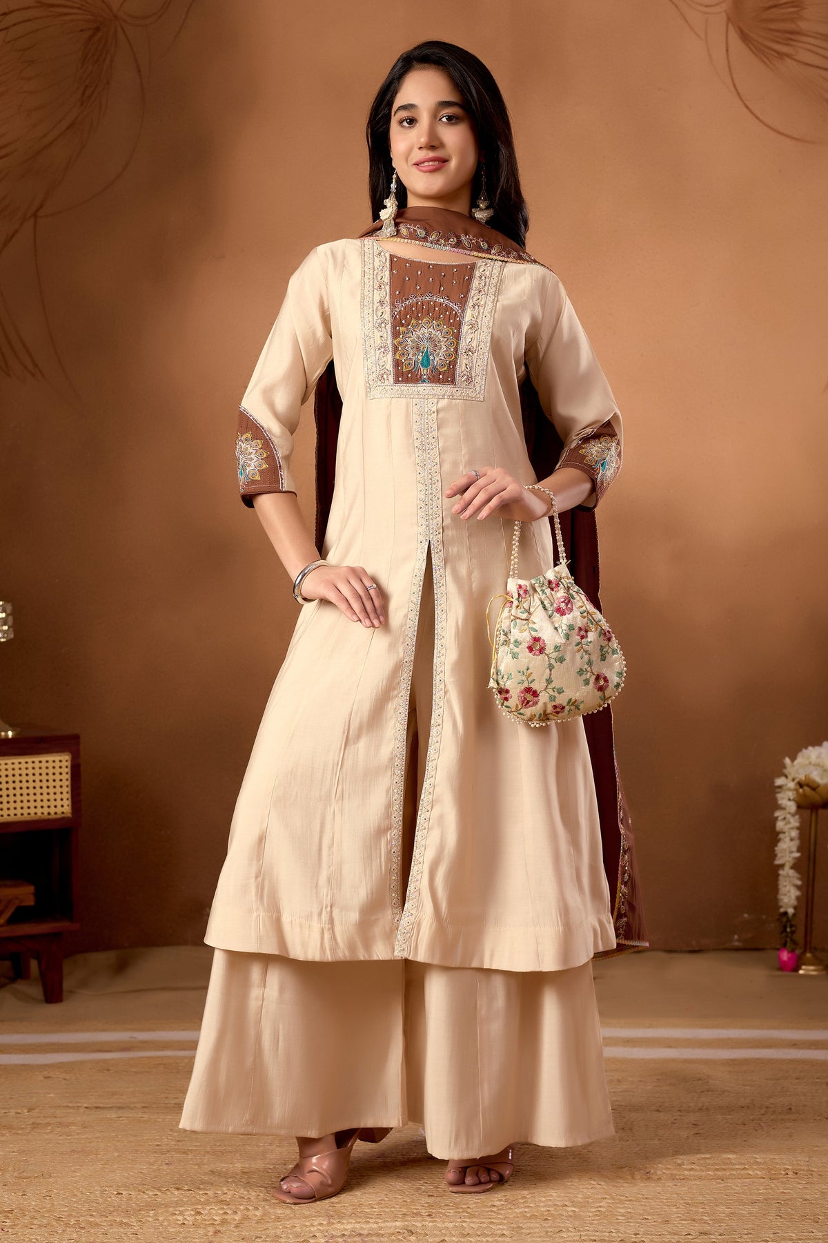 Cream Roman Silk kurta with multi-color embroidery and handwork details worn as a set with matching palazzo