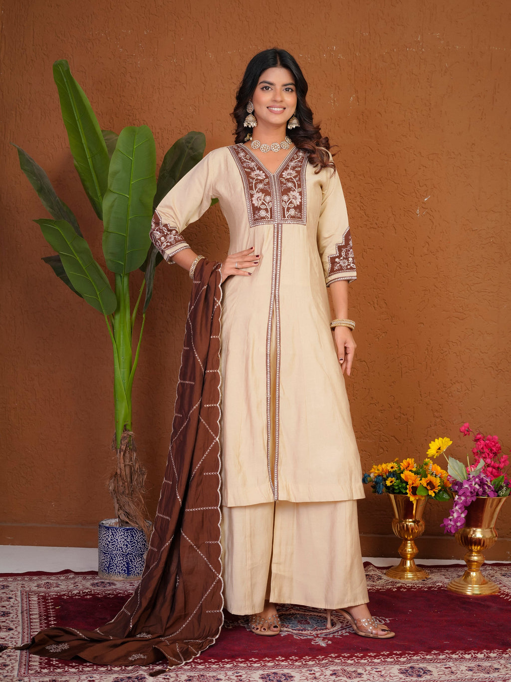 Elegant cream Roman silk kurta with multi-colored thread embroidery and hand work, paired with matching palazzo pants.