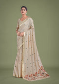 Beige and maroon cotton silk saree with woven butti patterns and golden Zari border