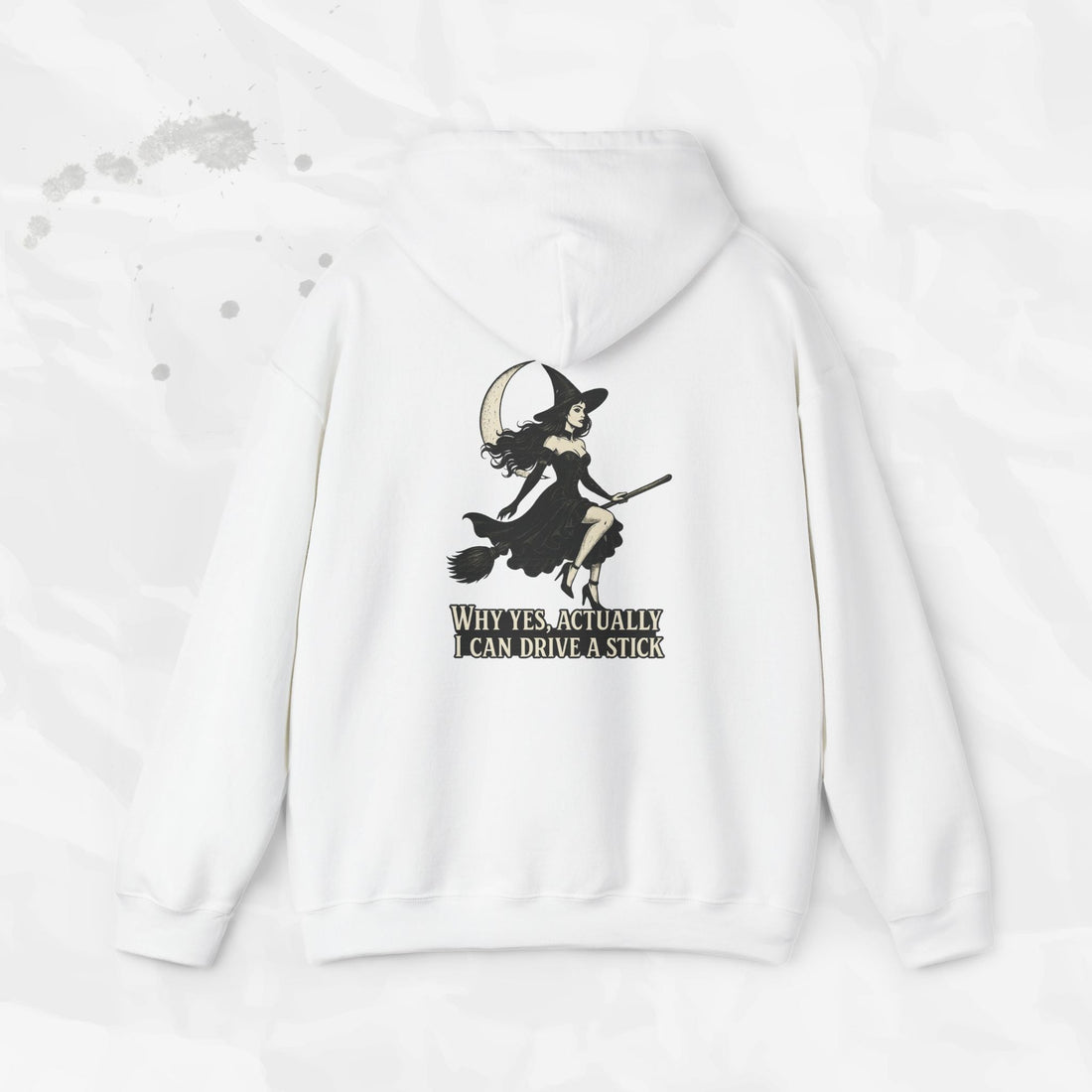 White and light pink hoodies showing a back print graphic of a witch on a broomstick with the text Why Yes Actually I Can Drive a Stick