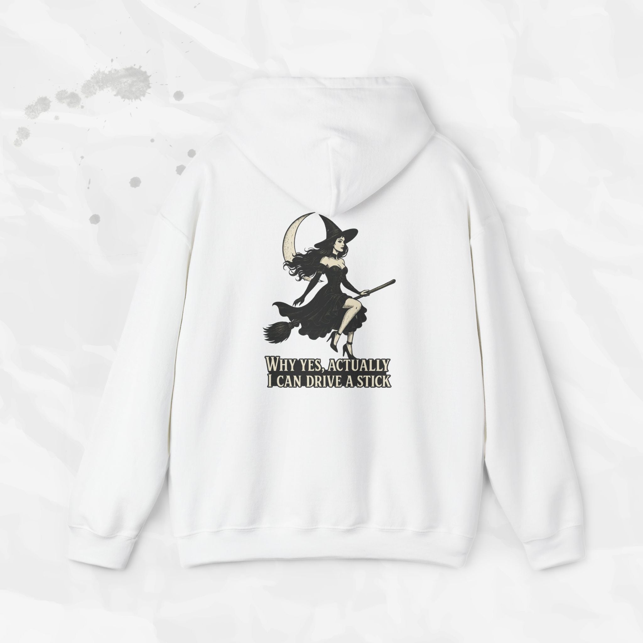 White and light pink hoodies showing a back print graphic of a witch on a broomstick with the text Why Yes Actually I Can Drive a Stick