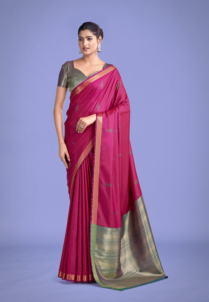 Rani pink silk saree featuring intricate golden zari woven border and motifs.
