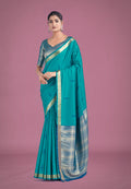 Turquoise silk saree with intricate golden zari woven border for ceremonies