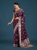 Wine colored Banarasi Satin Silk saree with intricate gold Zari woven borders.