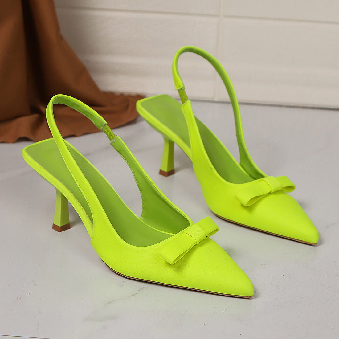 Women's satin stiletto pumps with bow detail and ankle strap