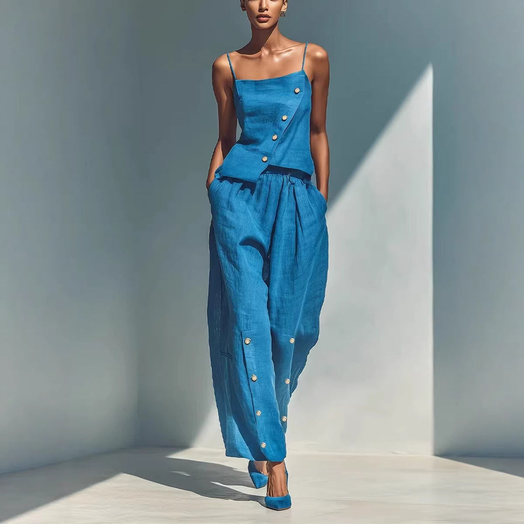 A woman wearing a two-piece matching set with an asymmetrical button camisole and wide-leg pants.