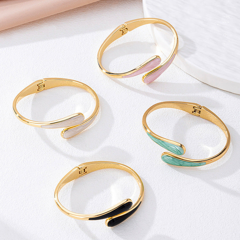 Modern vintage irregular open-end alloy bracelet in metallic finish on a white background.