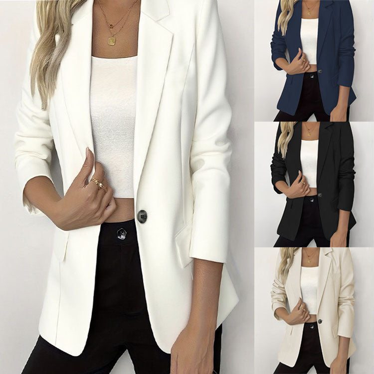 A woman wearing a beige tailored single-button blazer with a notch lapel, posing on a city street.