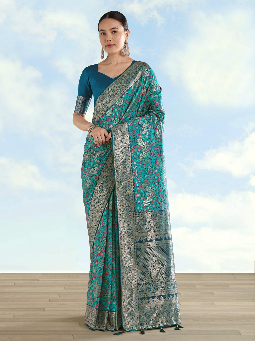 Turquoise Banarasi soft silk saree with intricate gold paisley zari weaves.