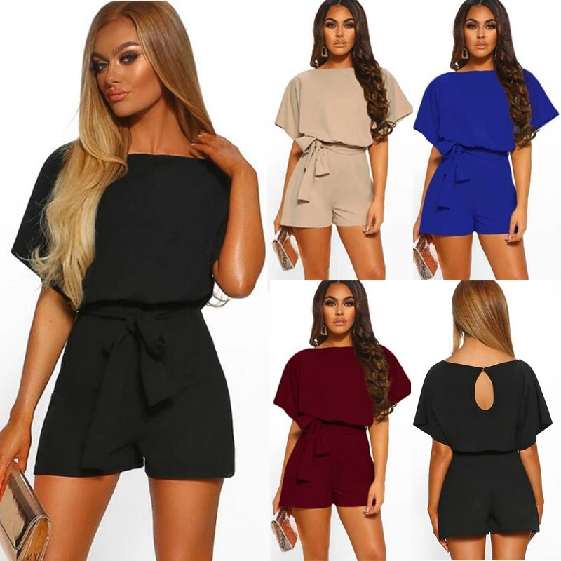 A model wearing a short-sleeve belted black mini jumpsuit, shown in multiple colors including beige, blue, and burgundy.