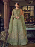 A floor-length Pista green embroidered butterfly net Anarkali suit with floral patterns and long sleeves.