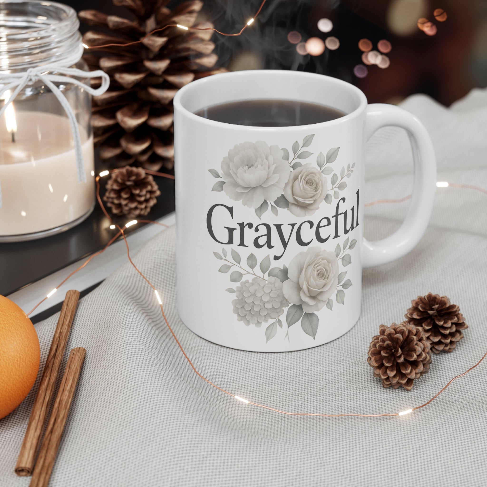 Minimalist white ceramic coffee mug with a delicate neutral floral pattern on a bright kitchen counter