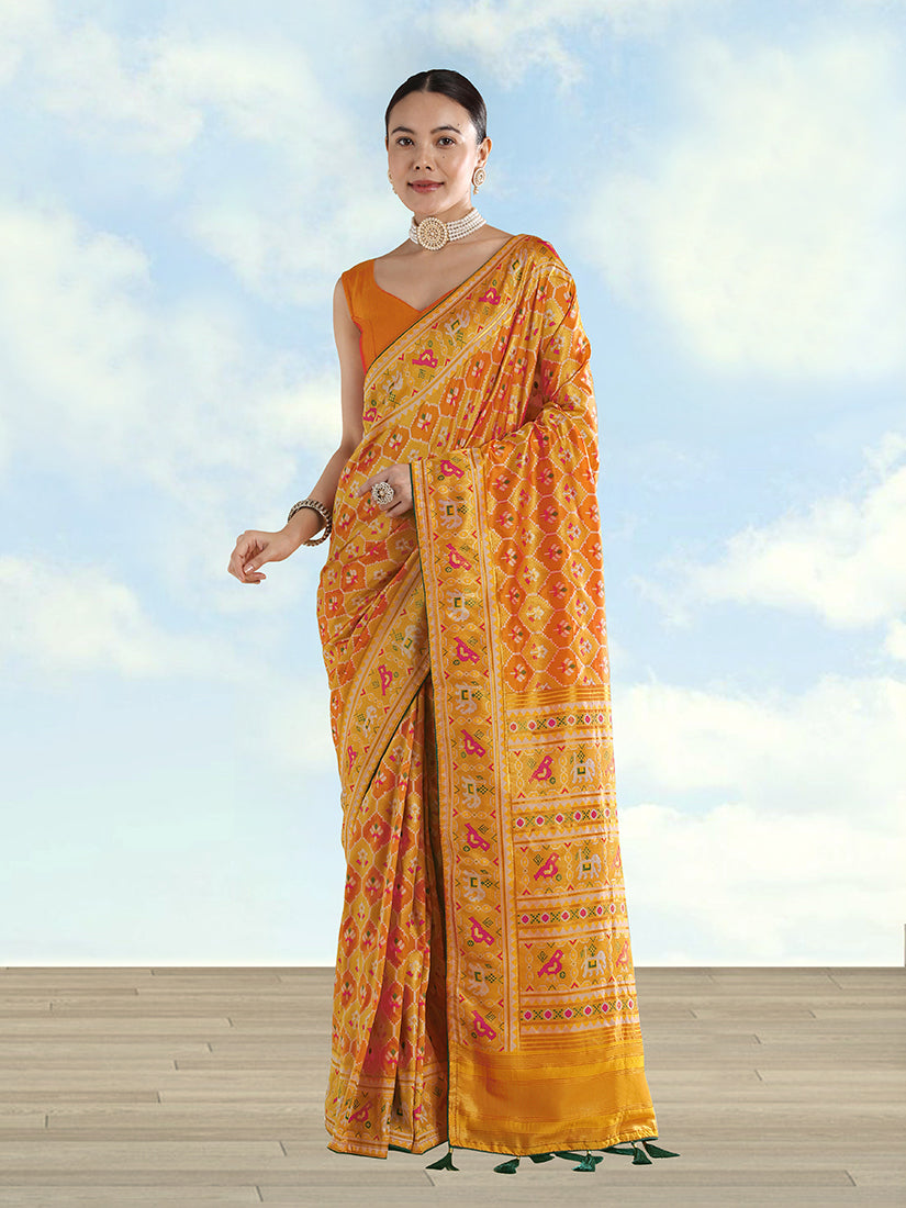 Mustard satin silk saree featuring intricate patola zari work and traditional elephant motifs.