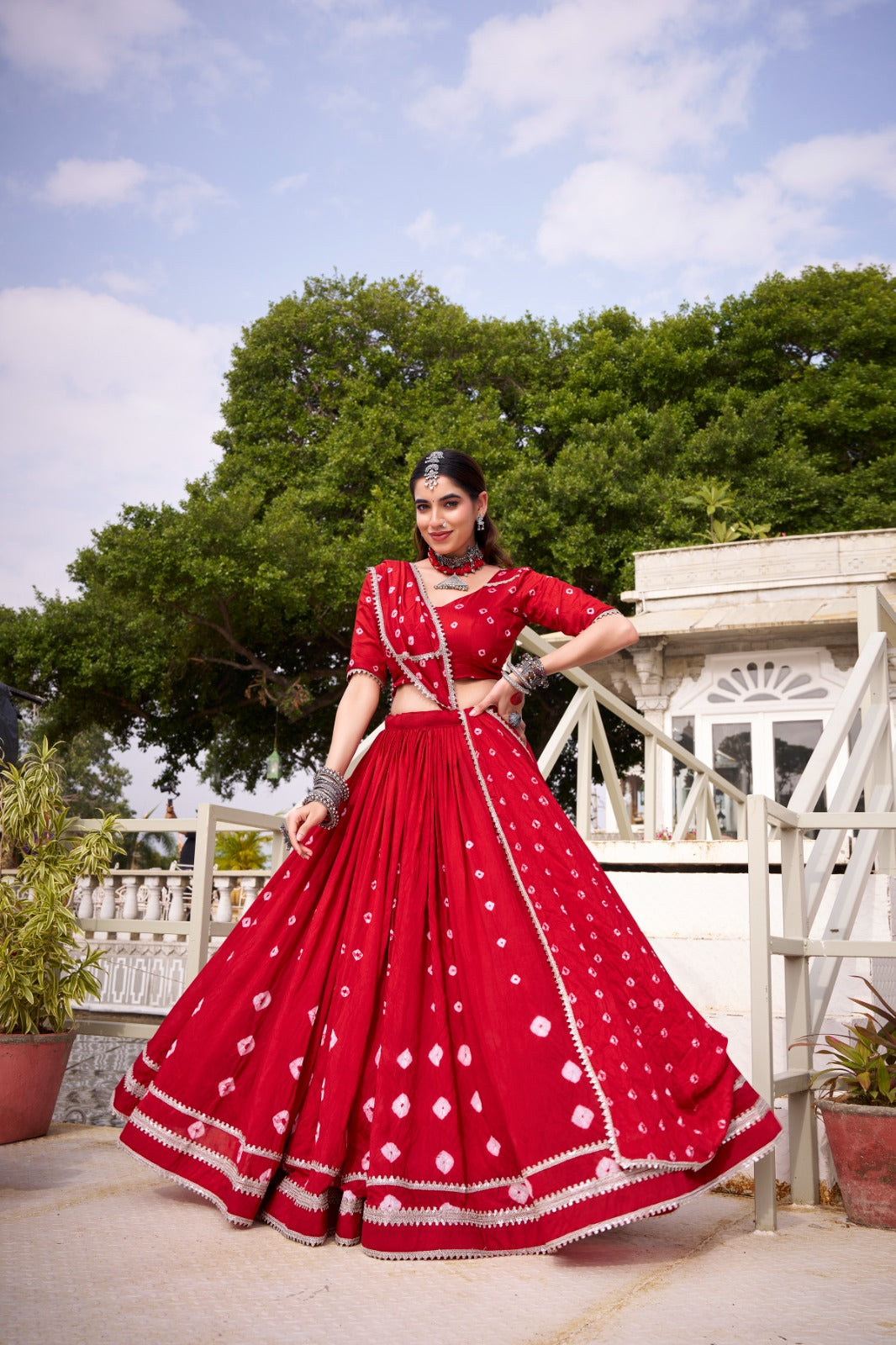 Red pure chanderi lehenga choli with traditional bandhej print and lace accents