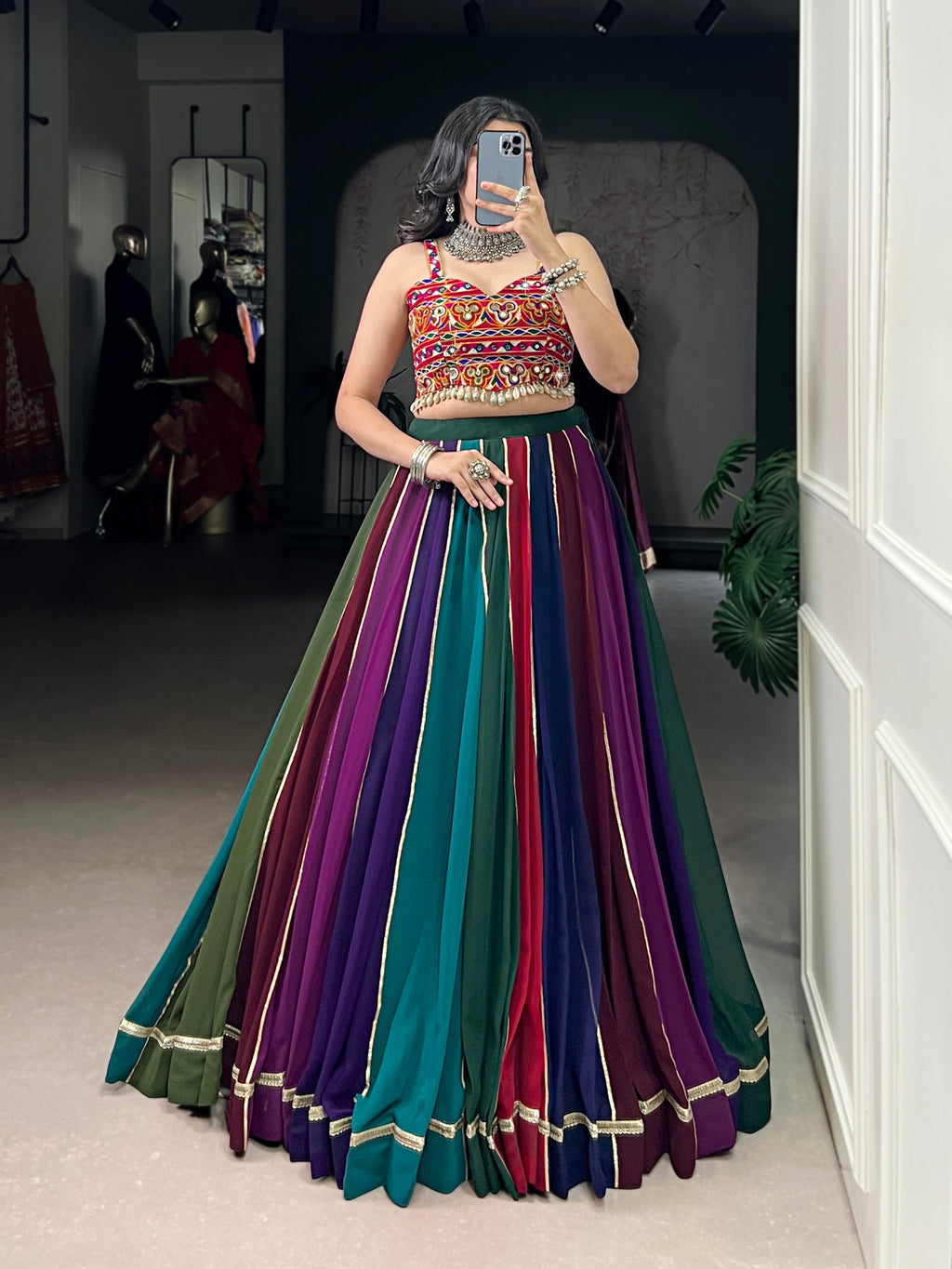 Multicolor striped georgette lehenga with lace trim, featuring green, purple, red, and blue shades.