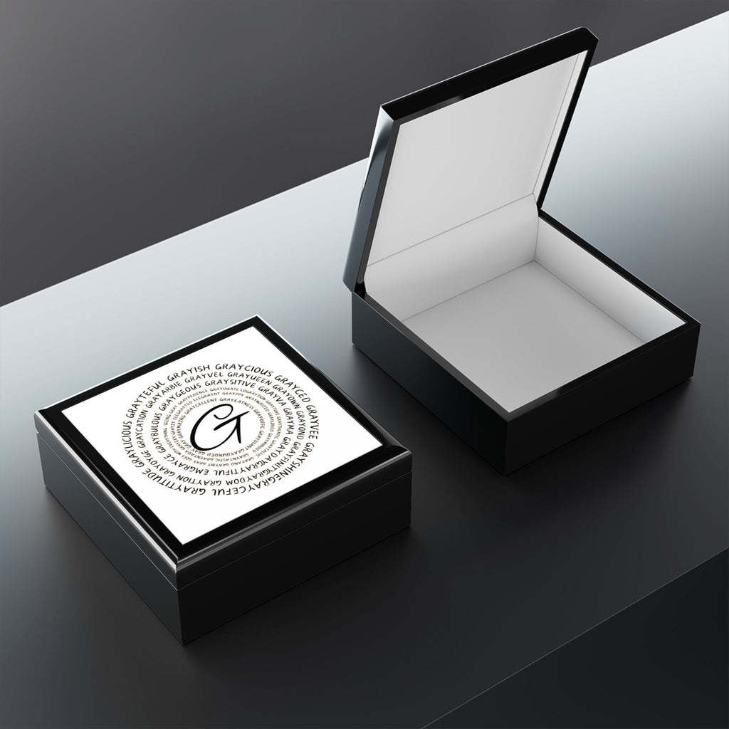 Modern wooden jewelry box with a glossy ceramic inlay and soft felt interior on a clean vanity surface.