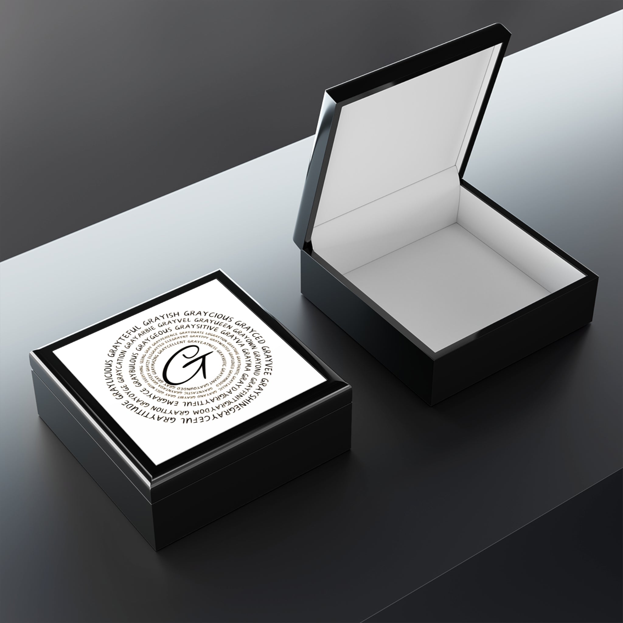 Modern wooden jewelry box with a glossy ceramic inlay and soft felt interior on a clean vanity surface.