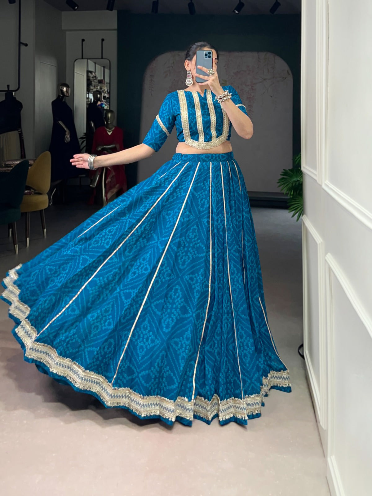 Firozi chiffon lehenga choli featuring Bandhej print, gold Gotta Patti lace, and sequin work for women.