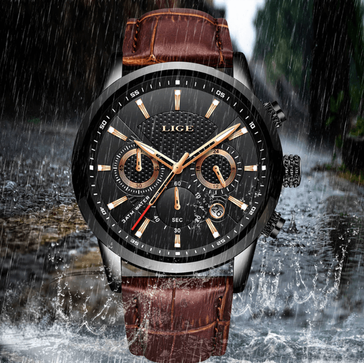 Close up of a professional men's chronograph sport watch with a stainless steel dial and leather strap.