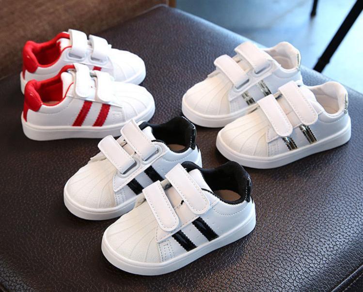 A pair of white, soft-bottom casual sport sneakers for babies and toddlers.