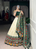 Off-white Tasar silk lehenga choli with Patola print and Gamthi mirror work