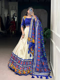 Off-white Tasar silk lehenga choli with Patola print, foil, and mirror work.
