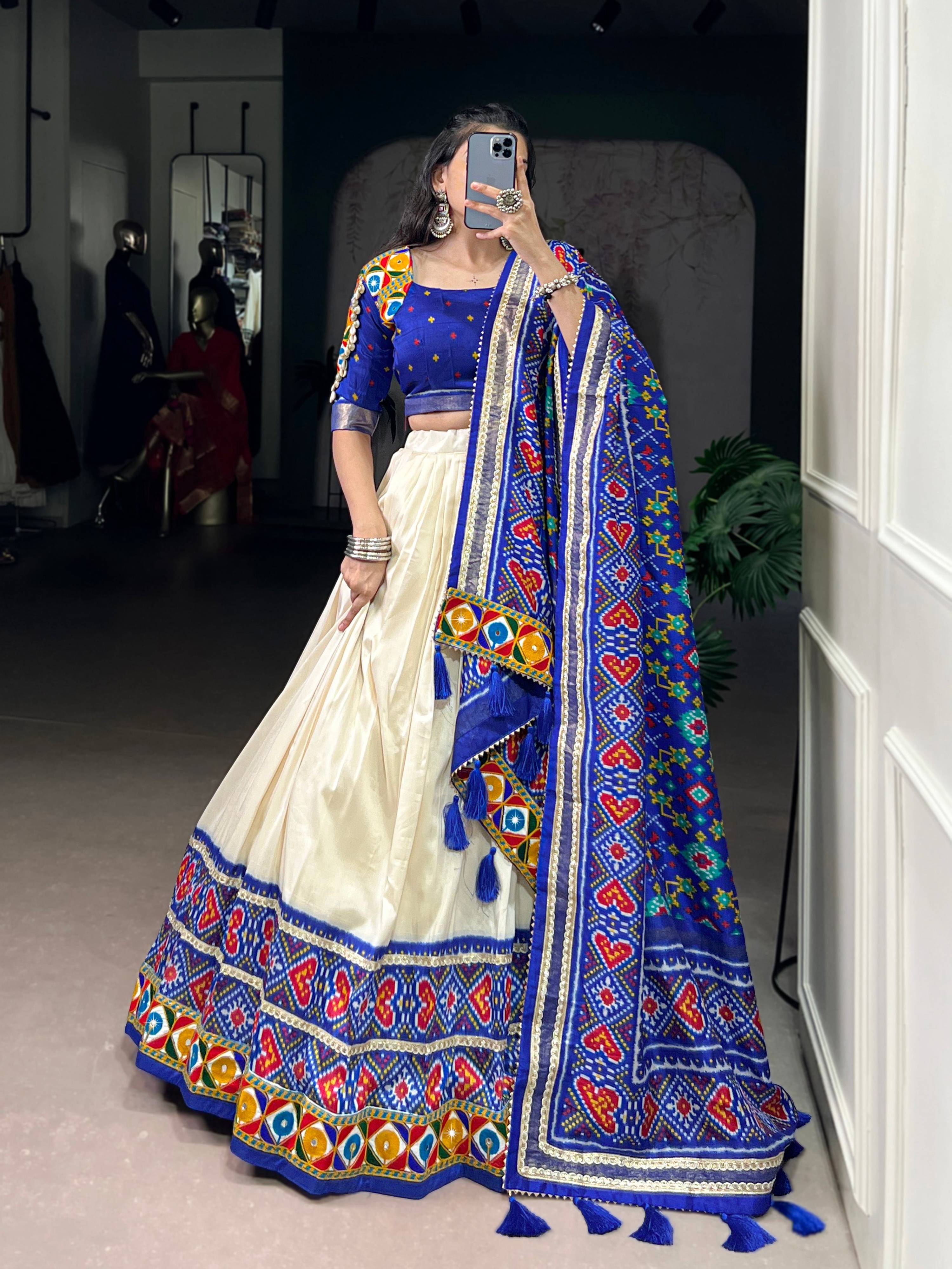 Off-white Tasar silk lehenga choli with Patola print, foil, and mirror work.