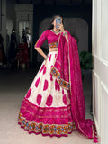 Close up of off-white Tasar silk lehenga with intricate magenta Bandhej pattern and lace trim.