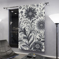 Elegant black and white floral patterned blackout curtains hanging in a bright living room