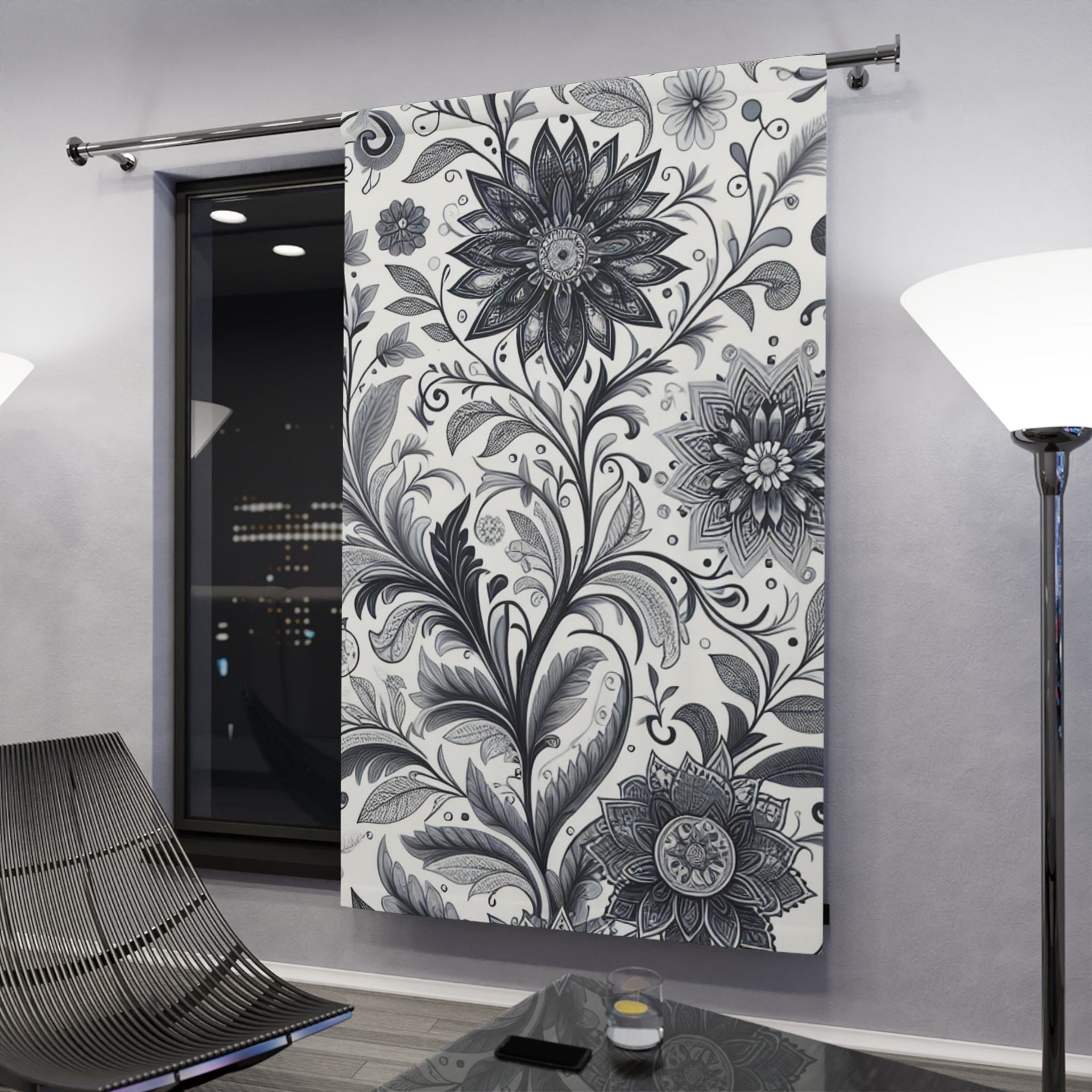 Elegant black and white floral patterned blackout curtains hanging in a bright living room