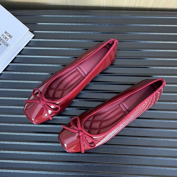 A top-down view of two pairs of women's square toe slip-on flats, one pair in deep red and one in cream with black trim, both featuring a decorative bow on the toe.