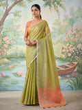 Elegant green tissue silk saree with matching blouse piece draped beautifully