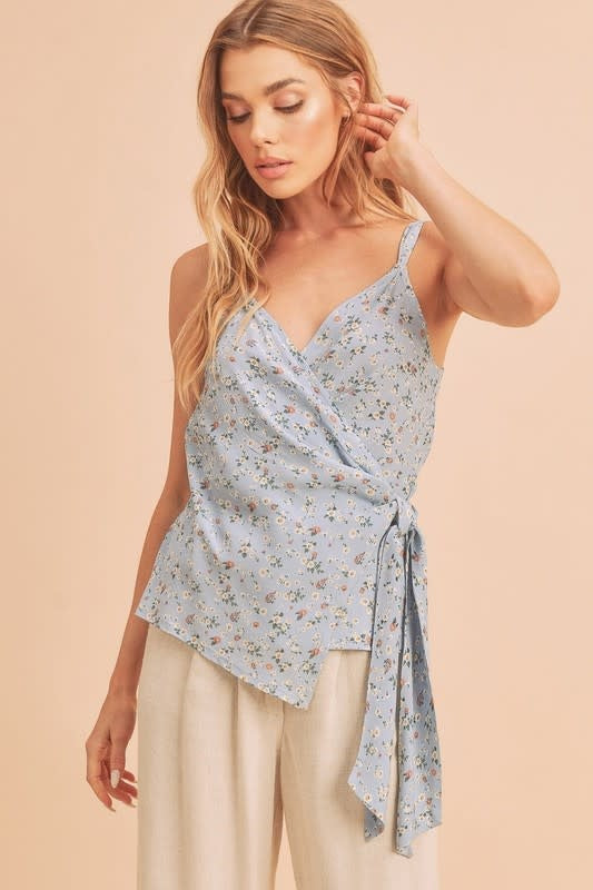 Front view of Malorie Top in Sky Floral print featuring a wrap-front design and waist tie.
