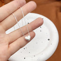 Close up of a 999 Sterling Silver Matte Heart Box Chain Necklace by Vera Lux