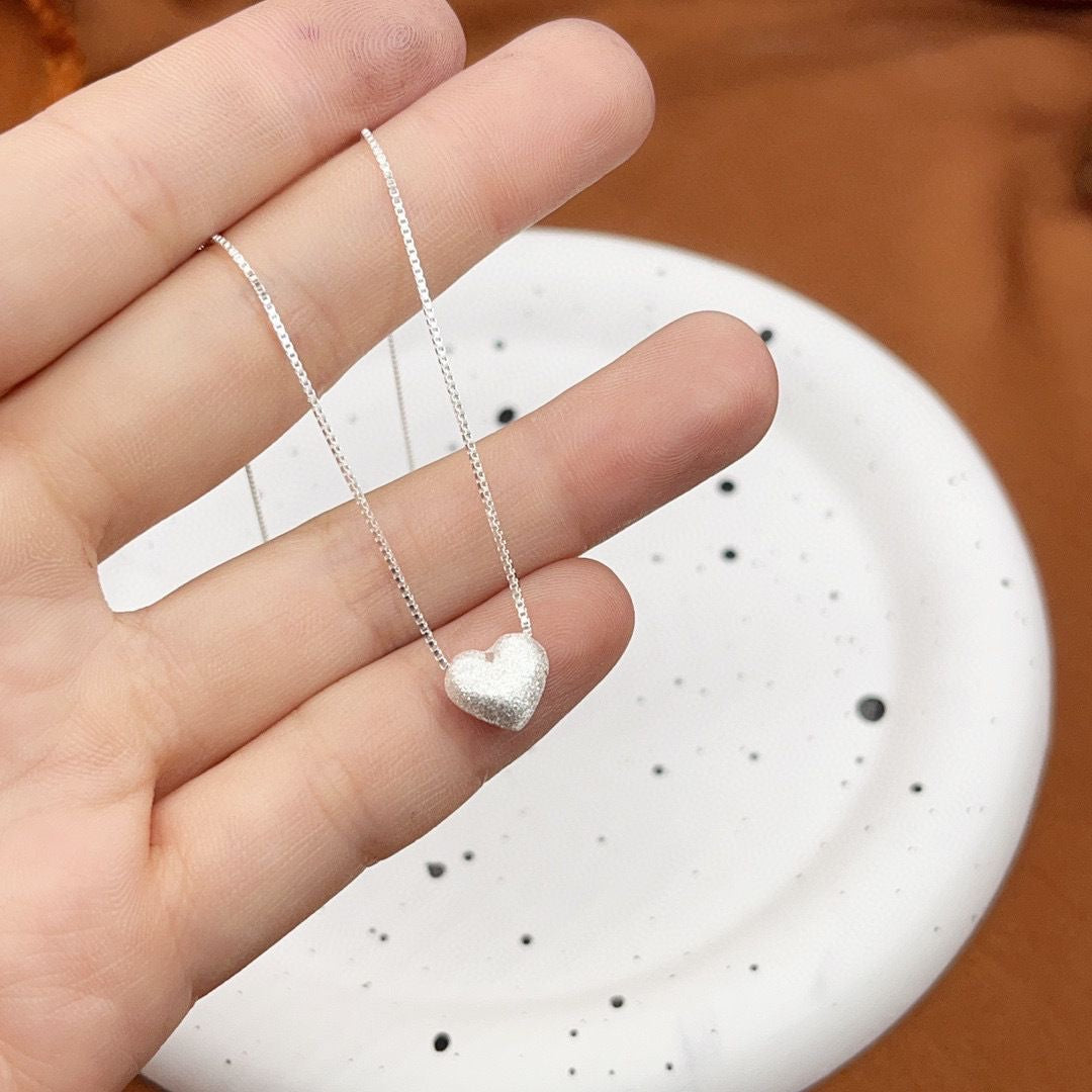 Close up of a 999 Sterling Silver Matte Heart Box Chain Necklace by Vera Lux