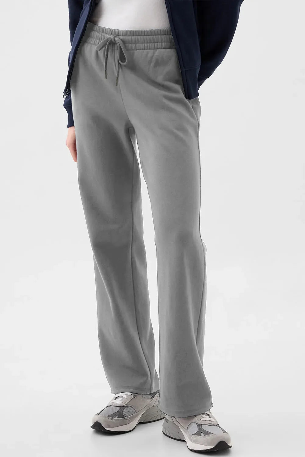 A pair of grey women's drawstring lounge pants with a relaxed fit, featuring side pockets and an elastic waistband.
