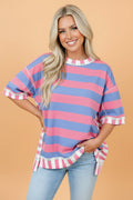 Oversized knit top featuring striped patchwork details and exposed seams in a variety of colors.