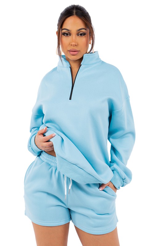 Model wearing a matching sweatshirt and short lounge set in a relaxed, comfortable fit.