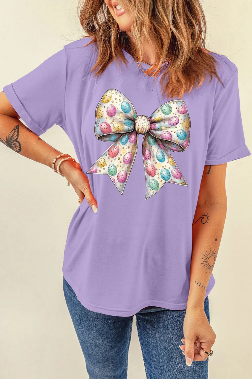 Lavender short sleeve round neck T-shirt featuring a festive bow graphic