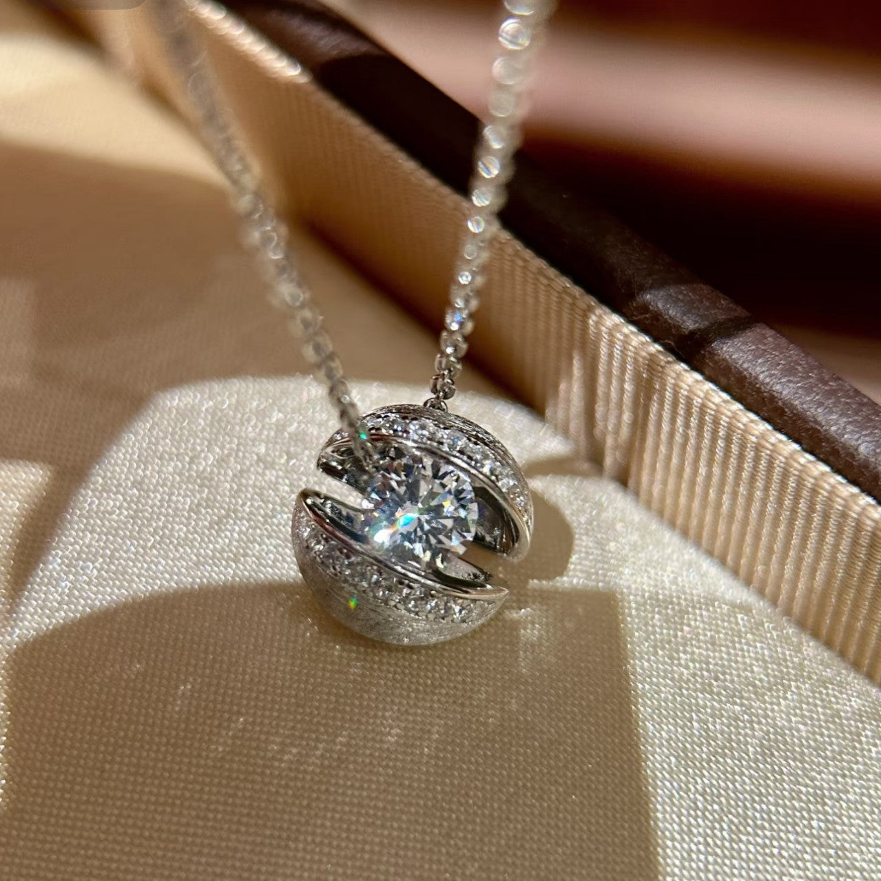 Minimalist floating planet design necklace with diamond inlay detail in silver