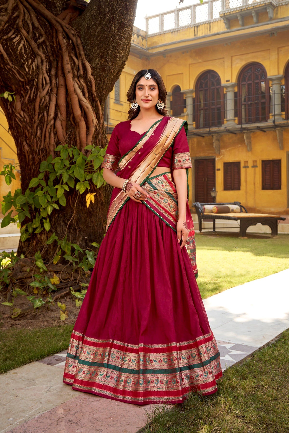 Woman wearing a maroon Pure Chanderi lehenga choli with traditional Zari weaving work