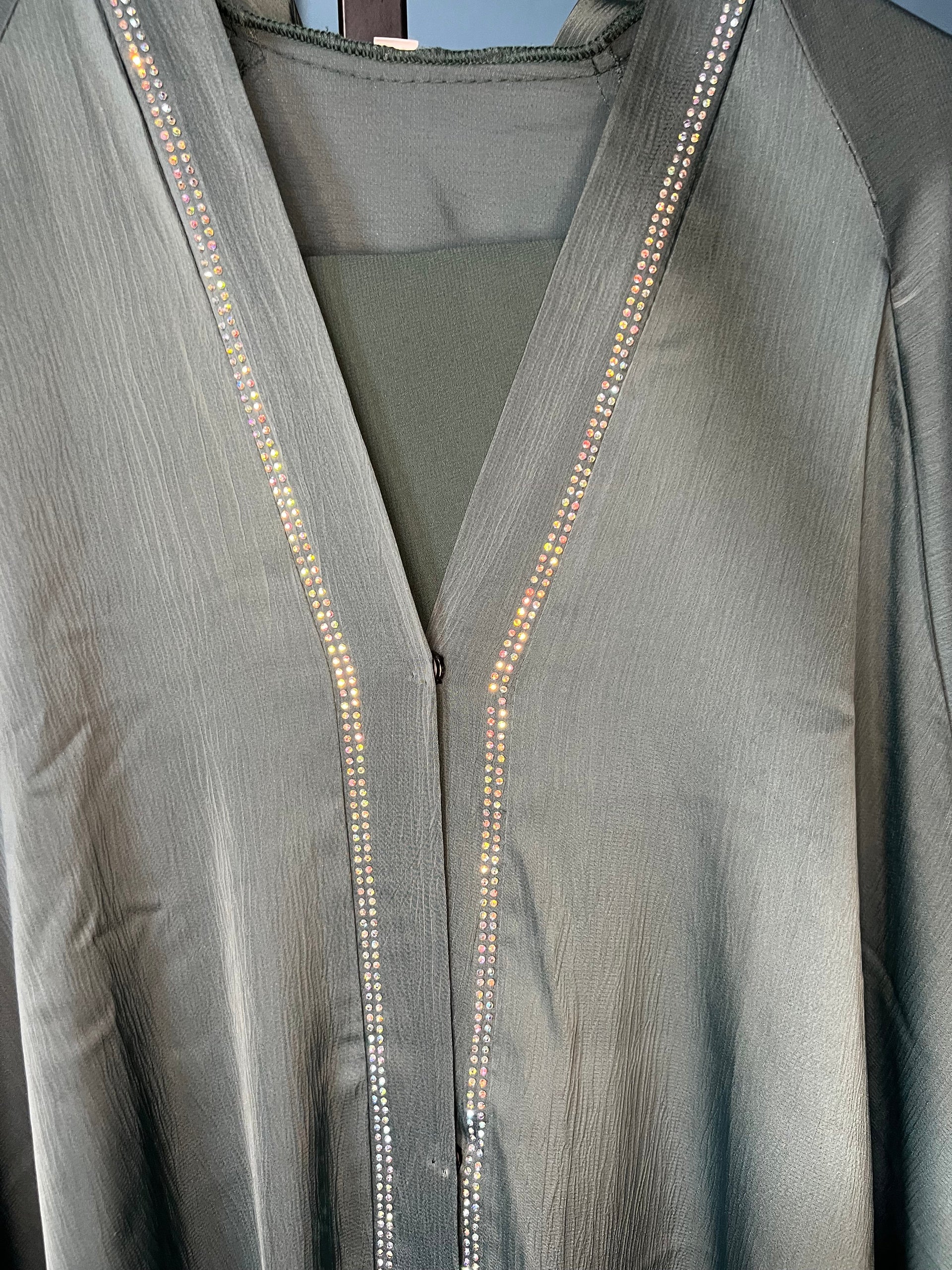 Teal-colored abaya with intricate rhinestone