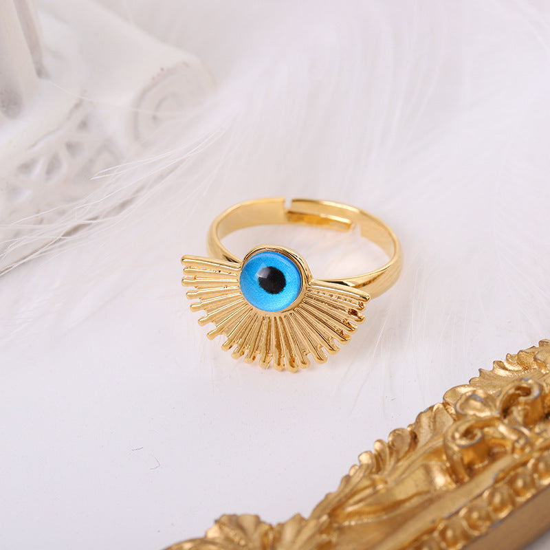 Gold-plated Evil Eye fan pendant necklace and matching adjustable ring with blue and black accents.